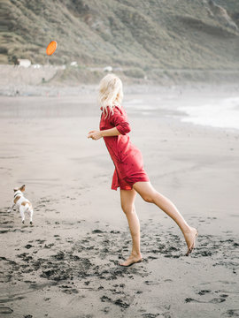 Woman throwing frisbee for dog