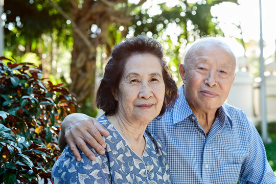 Happy Senior Asian Couple in a Park