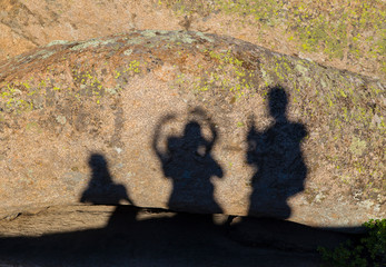 Shadows of happy people on the rocks