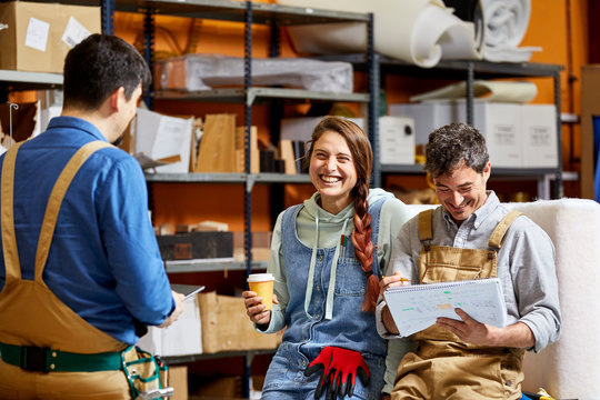 Smiling colleagues standing in workshop