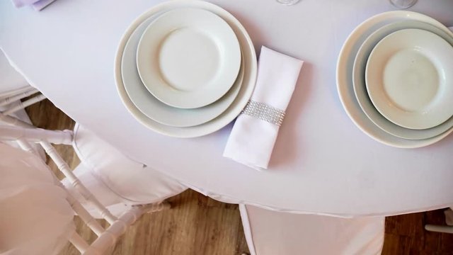 round table with a white tablecloth served plates wine glasses and napkins