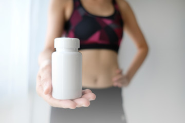 Fototapeta na wymiar woman workout vitamin supplement.slim weight lost