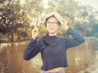 beautiful young Asia woman with reading book at outdoor garden.