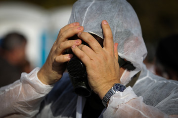 Man puting on a gas mask