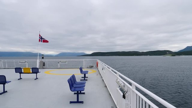 Ferry deck with empty seats and sea view in the background. Ferryboat ride route Bognes - Lodingen to Lofoten islands Norway. Tourism vacation and travel