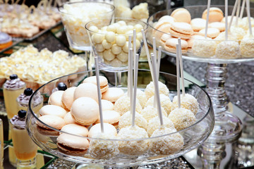 cheerful wedding celebration with a beautiful festive table, treats, champagne glasses, candles, flowers in the restaurant with a magnificent decor