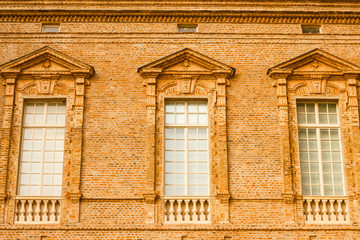 detail of a facade of a building from the 1600/detail of a balcony of a building of 1600 with the typical brick facade of the 1600. 