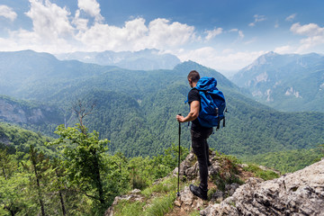 Fototapeta na wymiar Male hiker with backpack enjoying at breathtaking view