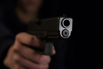 A person pointing a handgun