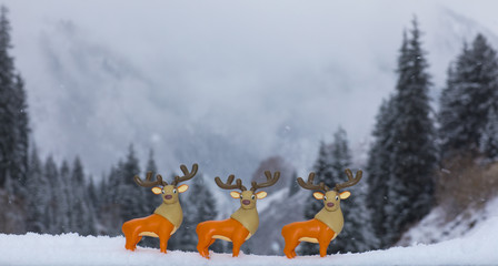 Christmas toy deer in the winter forest