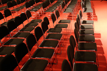 Free chairs in row in an empty auditorium
