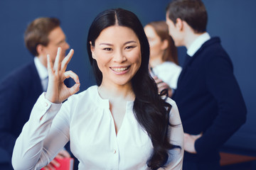Attractive Smiling Woman Showing Ok In Office. Happy After Productive Meeting. Business Concept.