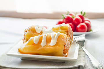 Stuffed pepper with meat and rice on a white square plate