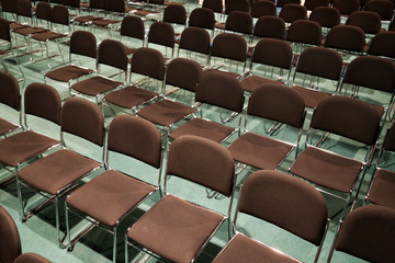 Free chairs in row in an empty auditorium