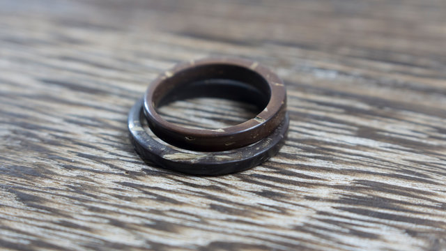 Imperfect Handmade Coconut Rings In Wooden Background. Unique Pair Of Artisan Wedding Ring Bands. Love And Union Concept