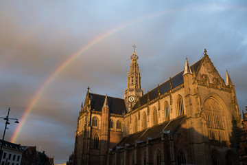 Fototapeta na wymiar Rainbow above Sint Bavo in Haarlem
