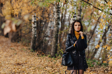 Fototapeta na wymiar cozy stylish young girl walk at autumn colorful park make photos