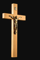 Wooden illuminated crucifix on a black background