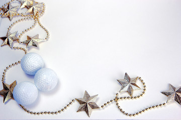 Golden stars, shiny yellow glass balls and white golf balls. Christmas and New Year holiday background concept. Copy space for text.