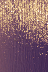 Golden bokeh on purple background