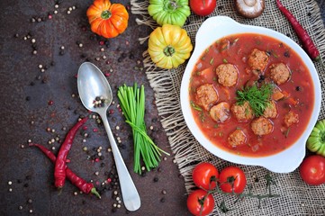 Portion of tomato soup with meatballs 