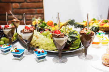 Modern desserts, cupcakes, sweets with fruits. Delicious candy bar. © VAKSMANV