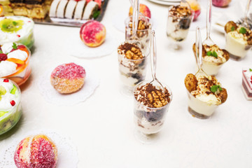 Modern desserts, cupcakes, sweets with fruits. Delicious candy bar. Catering Concept.