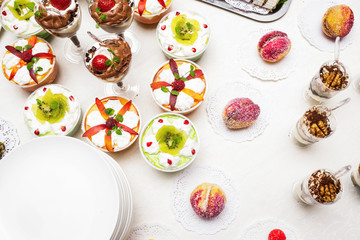 Modern desserts, cupcakes, sweets with fruits. Delicious candy bar. Catering Concept.