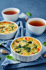 Spinach Red Bell Pepper Baked Omelet with cups of tea and fresh spinach leaves
