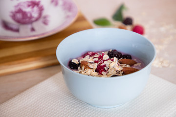 Tasty granola bowl with fresh fruits and nuts