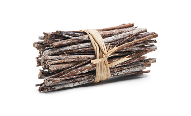 Side view of dry twigs tied in a bundle with natural twine isolated on a white background.
