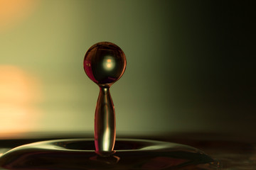 Drops of rain fall into the water, selective focus close-up