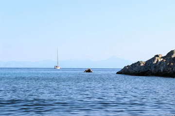 Sailboat on water near land horizontal