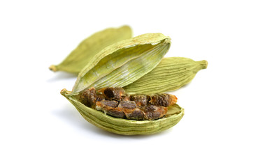 Green cardamon seeds isolated on a white background.