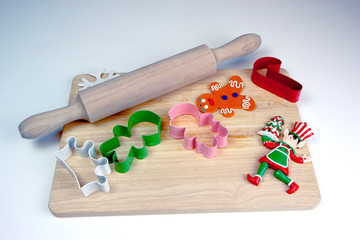 Flour, wooden rolling pin and cutting board, cookie cutters, gingerbread man. Christmas and New Year holiday background concept. Copy space for text.