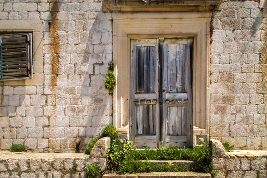 old wooden door in stone wall