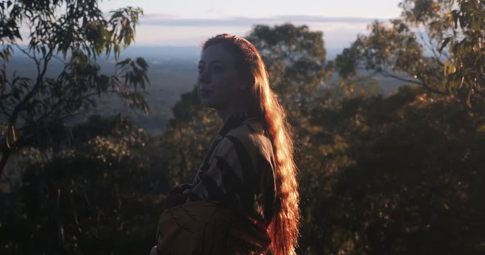 Young Woman Enjoys Morning Sunlight in Nature
