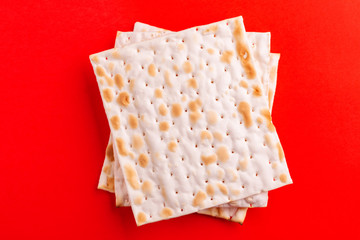 Traditional Jewish kosher matzo on bright red background