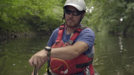 Paddling down the river in a canoe