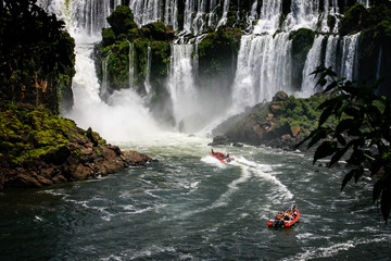 Speed boat rides under the water cascading over the Iguacu falls in Brazil