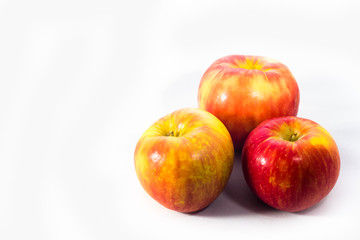 three crisp apples against a white background