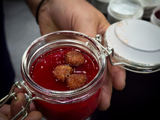 Strawberry jam in an open jar.