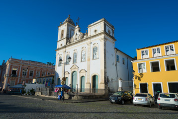 Fototapeta na wymiar Bright scenic view of classic colonial Portuguese church architecture in a plaza in the historic Pelourinho neighborhood in Salvador, Bahia, Brazil
