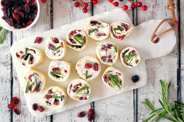 Cranberry, cream cheese roll-up appetizers. Holiday food concept. Top view, on a white background.