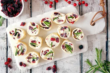 Outdoor kussens Cranberry, cream cheese roll-up appetizers. Holiday food concept. Top view, on a white background. © Jenifoto