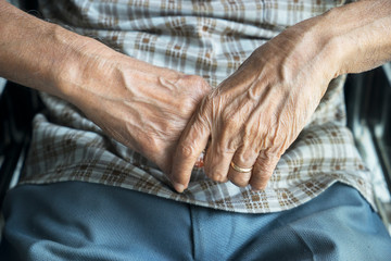 Fototapeta premium Wrinkled hands of disabled old man