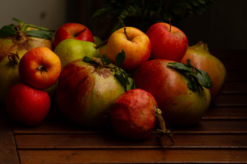 Composition of Autumn fruits (pomegranates, apples, pears)