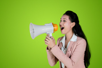 Young business woman speaking with megaphone
