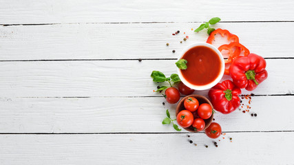 Tomato paste from fresh tomatoes. Ketchup sauce. Top view. On a wooden background. Free copy space.