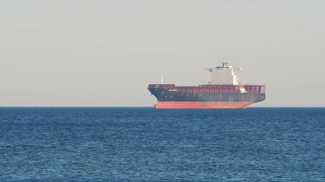 Genoa, Italy _ June  08, 2017:  Empty Container  cargo ship UASC Bubiyan anchored off the harbor awaiting  loading